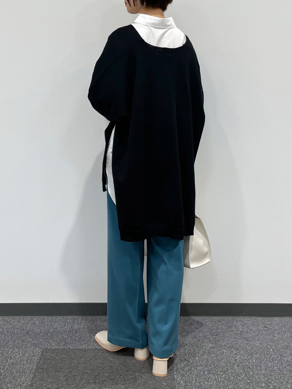 ブラック系のニット/セーター、ホワイト系のシャツ/ブラウス、ブルー系のその他パンツを着用したレディースの秋コーディネートの2枚目の写真