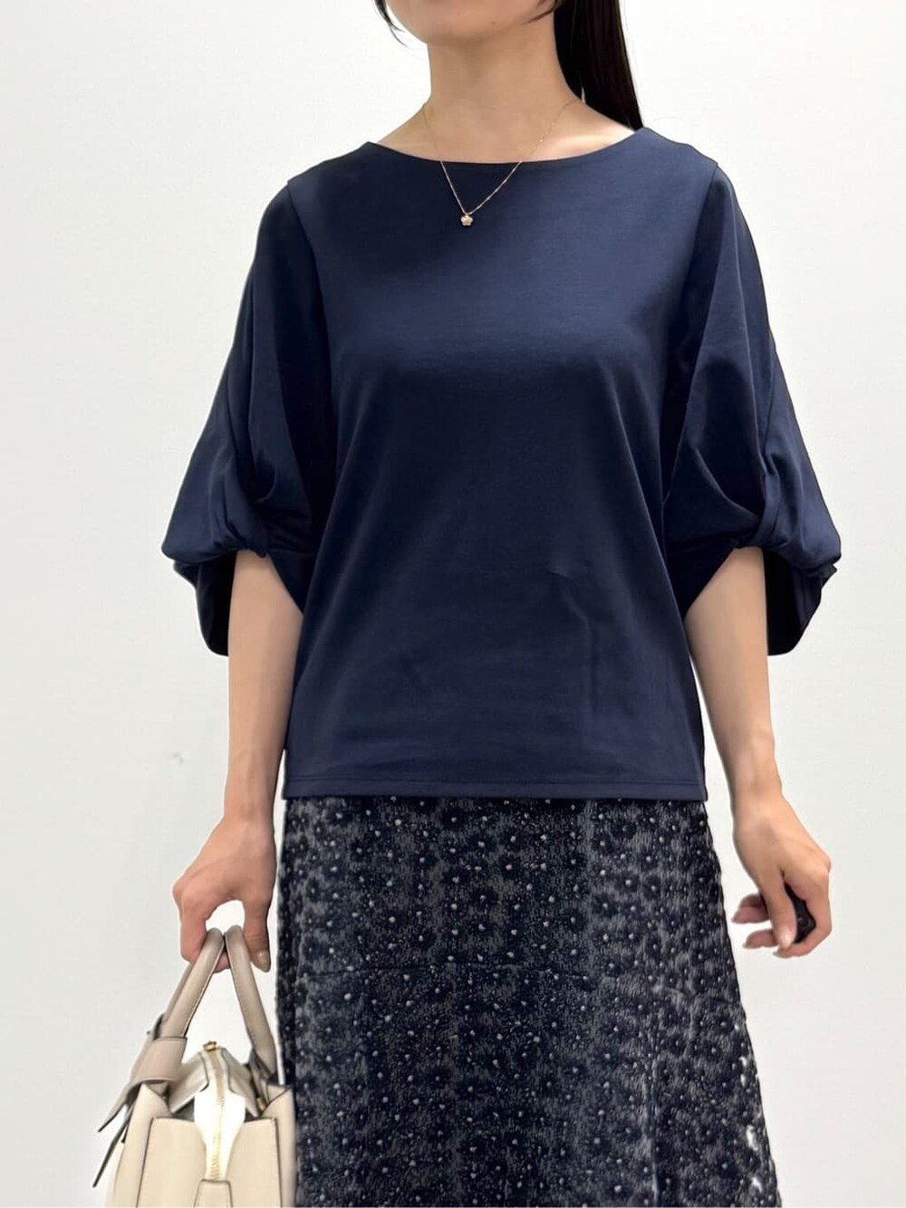 ブルー系のTシャツ/カットソー、ブルー系のスカート、ホワイト系のトートバッグを着用したレディースの秋コーディネートの6枚目の写真