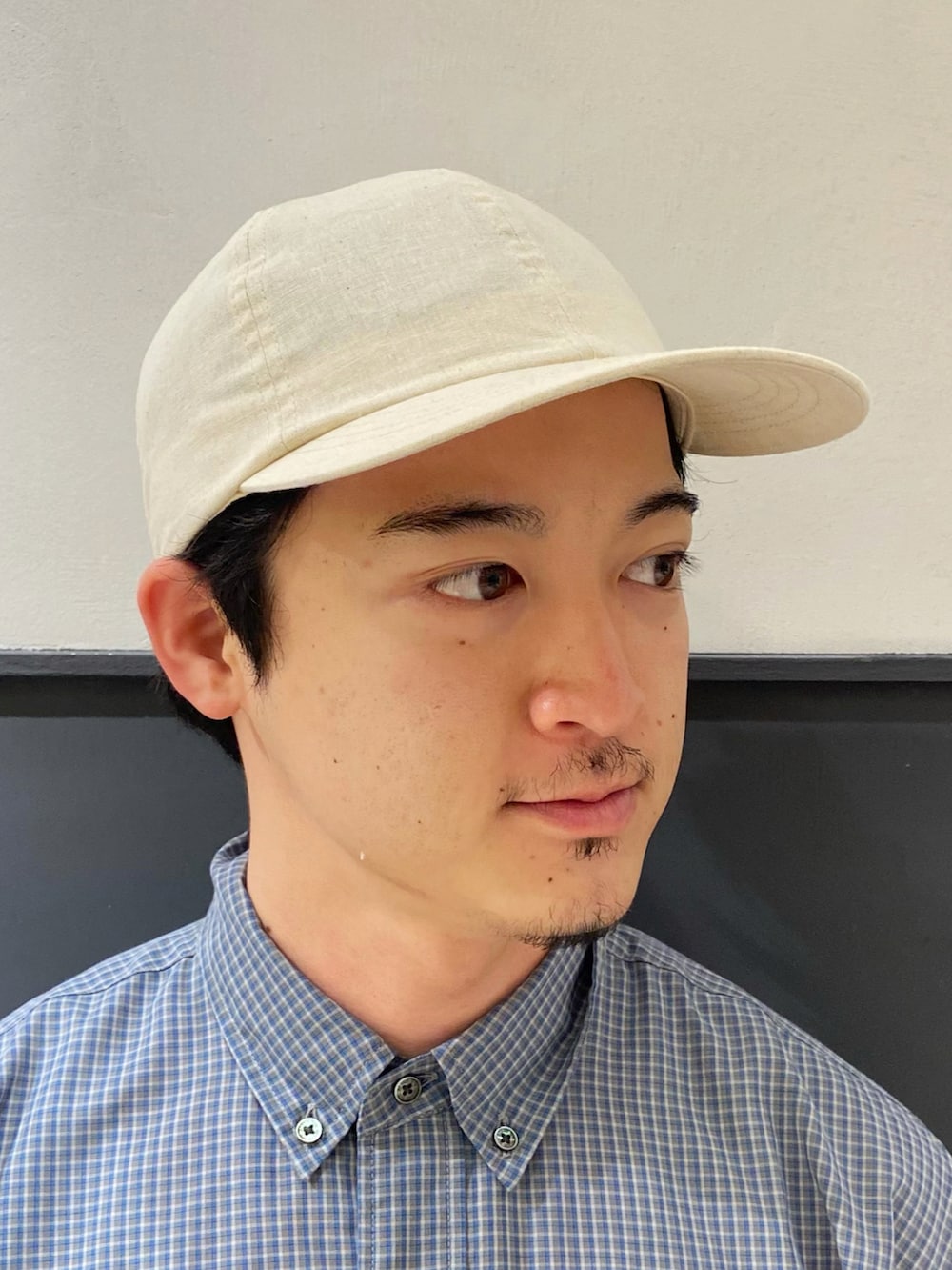 ブルー系のシャツ/ブラウス、グレー系のスラックス、ホワイト系のスリッポンを着用したメンズの夏コーディネートの3枚目の写真