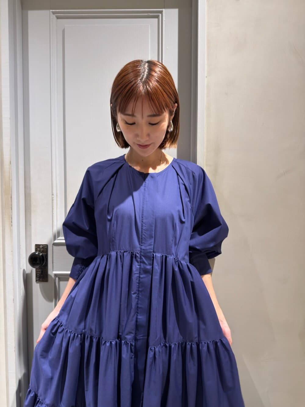 ブルー系のワンピース、グレー系のスニーカーを着用したレディースの秋コーディネートの4枚目の写真