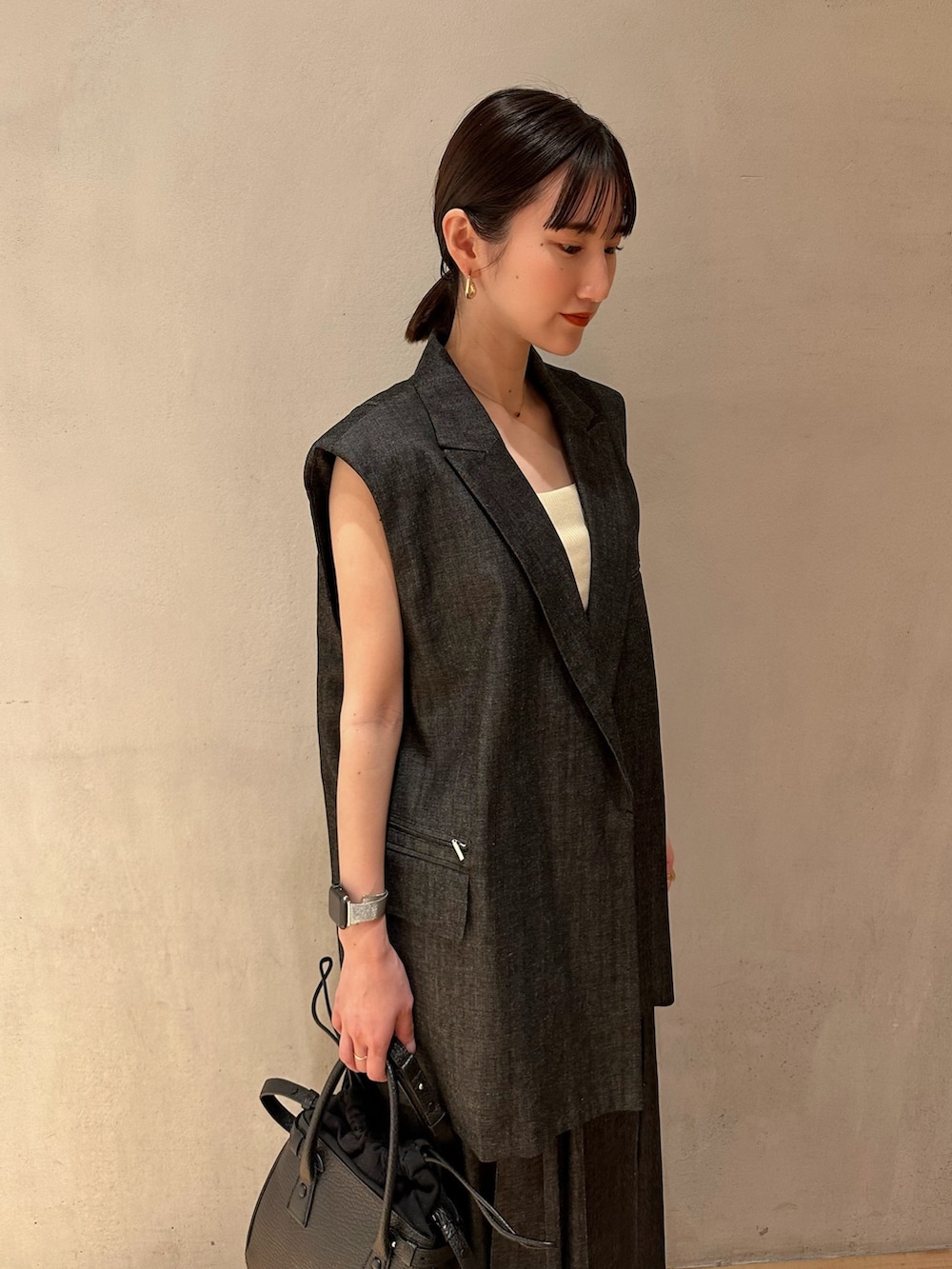 ゴールド系のパンプス、イエロー系のタンクトップ、その他のテーラードジャケットを着用したレディースの春コーディネートの5枚目の写真