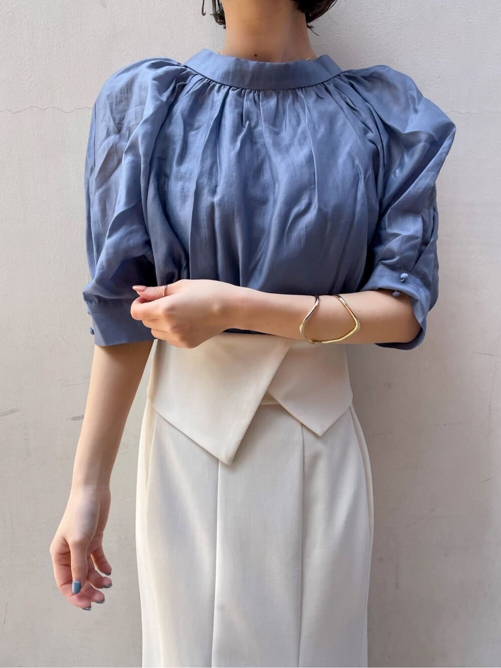 ホワイト系のスカート、ブラウン系のパンプス、ブルー系のシャツ/ブラウスを着用したレディースの春コーディネートの3枚目の写真