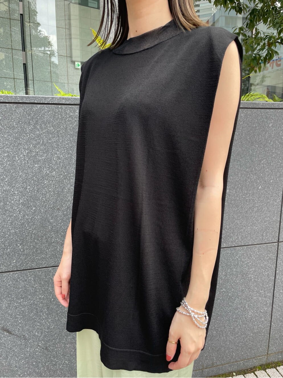 グリーン系のその他パンツ、ブラック系のニット/セーター、シルバー系のネックレスを着用したレディースの夏コーディネートの2枚目の写真