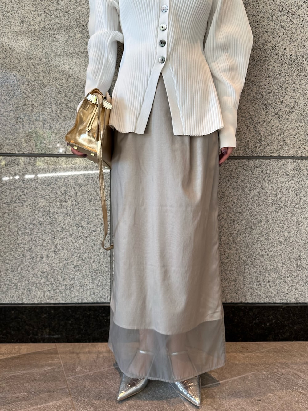 ホワイト系のカーディガン/ボレロ、ベージュ系のスカート、シルバー系のサンダルを着用したレディースの秋コーディネートの8枚目の写真