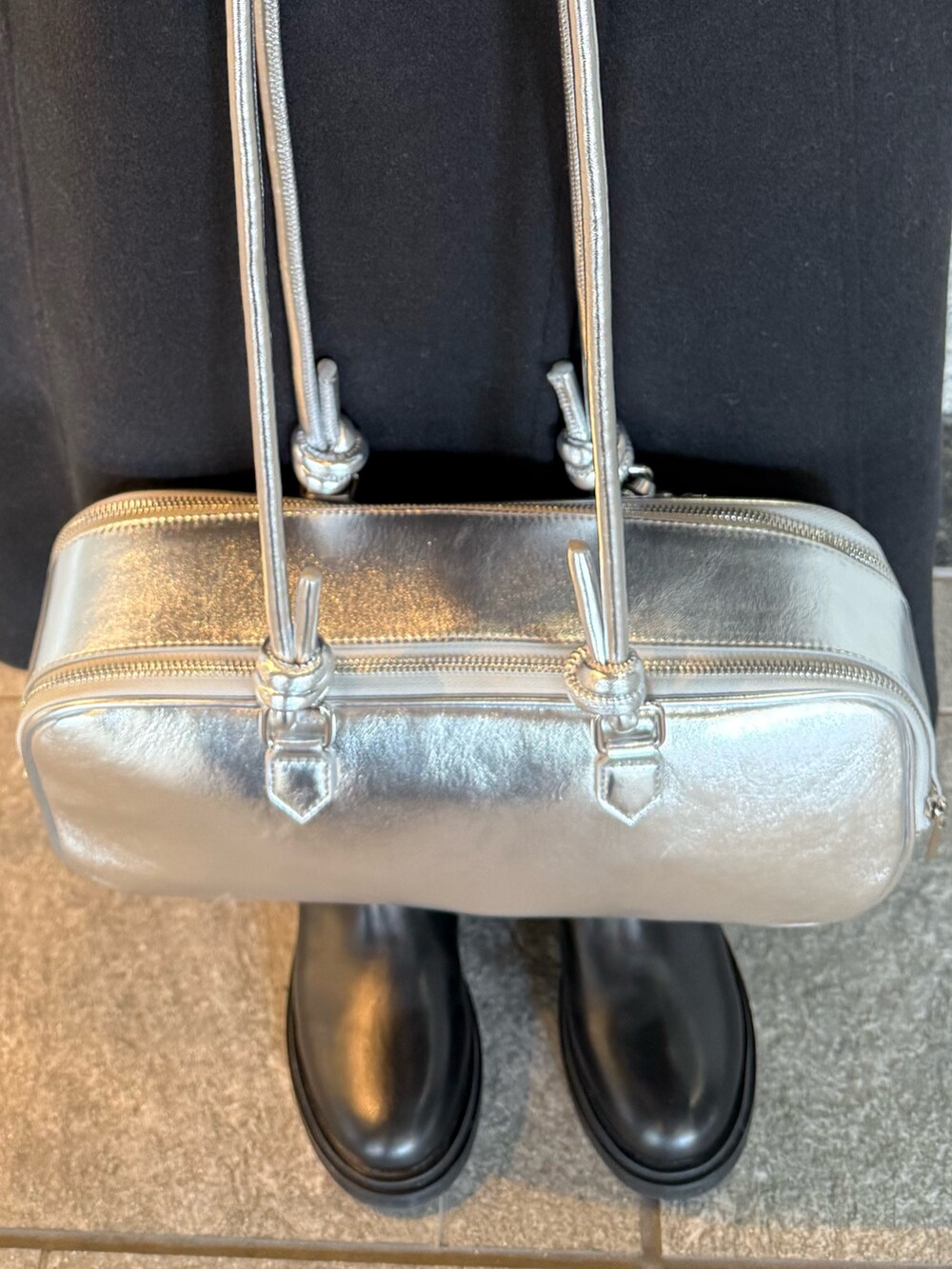 ブラック系のその他アウター、シルバー系のボストンバッグ、ブラック系のブーツを着用したレディースの冬コーディネートの8枚目の写真