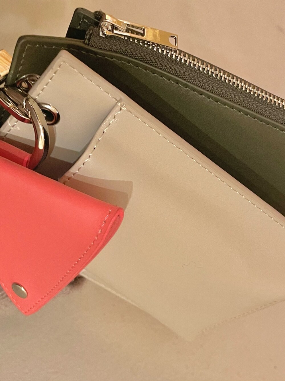 ベージュ系のショルダーバッグ、グリーン系のスカート、ブラック系のスニーカーを着用したレディースの秋コーディネートの7枚目の写真