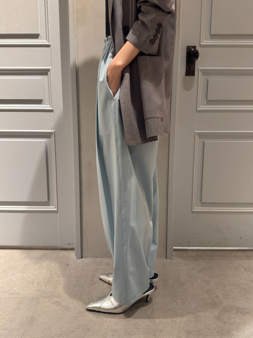 グレー系のテーラードジャケット、グリーン系のその他パンツ、シルバー系のパンプスを着用したレディースの冬コーディネートの10枚目の写真