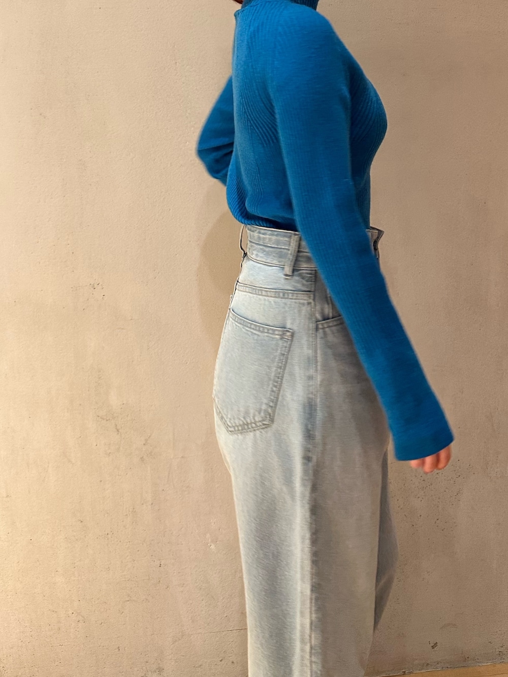 ブラック系のノーカラージャケット、ブルー系のニット/セーター、ブルー系のデニムパンツを着用したレディースの夏コーディネートの8枚目の写真