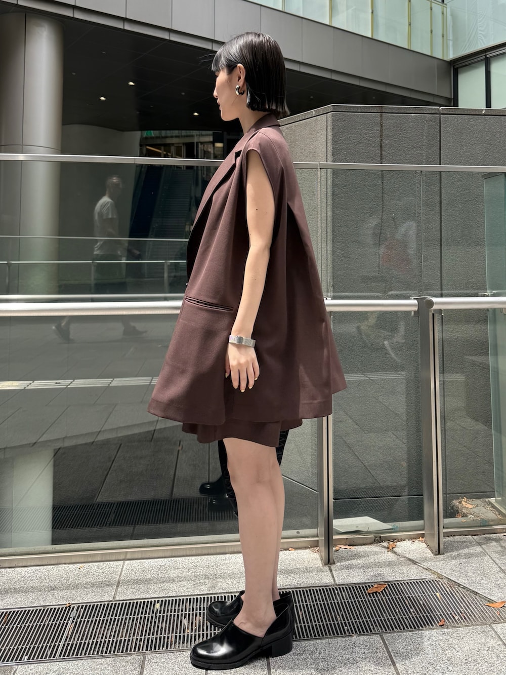 ブラウン系のテーラードジャケット、ブラウン系のその他パンツ、ブラック系のパンプスを着用したレディースの夏コーディネートの4枚目の写真