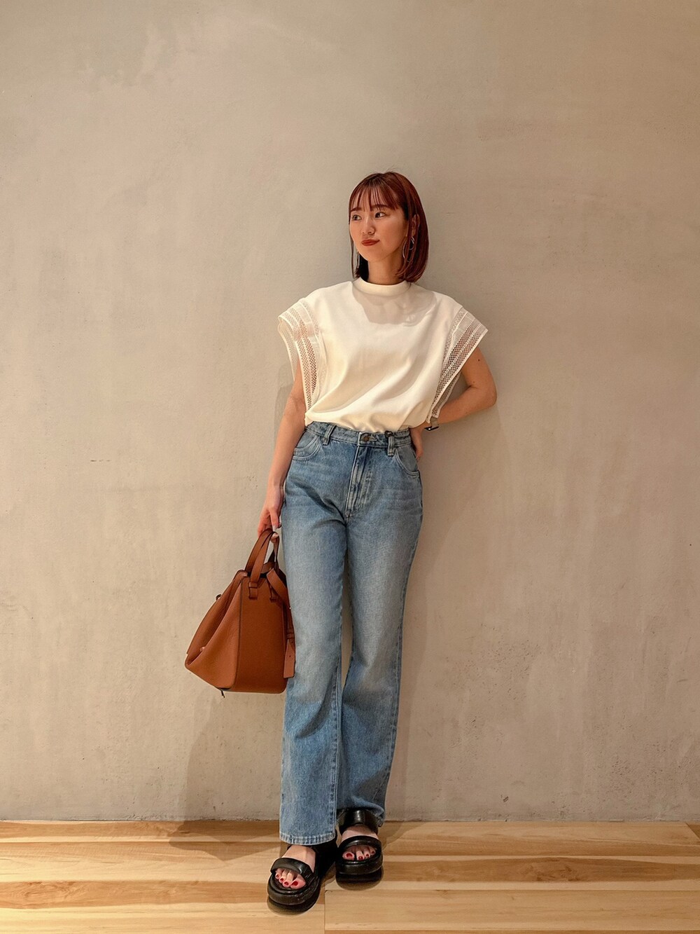 ホワイト系のTシャツ/カットソー、ブラック系のサンダル、ゴールド系のピアス（両耳用）を着用したレディースの夏コーディネートの2枚目の写真