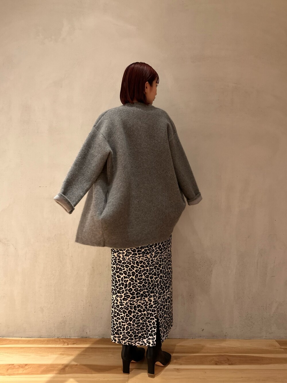 ホワイト系のスカート、ブラック系のブーツ、ブルー系のニット/セーターを着用したレディースの夏コーディネートの6枚目の写真