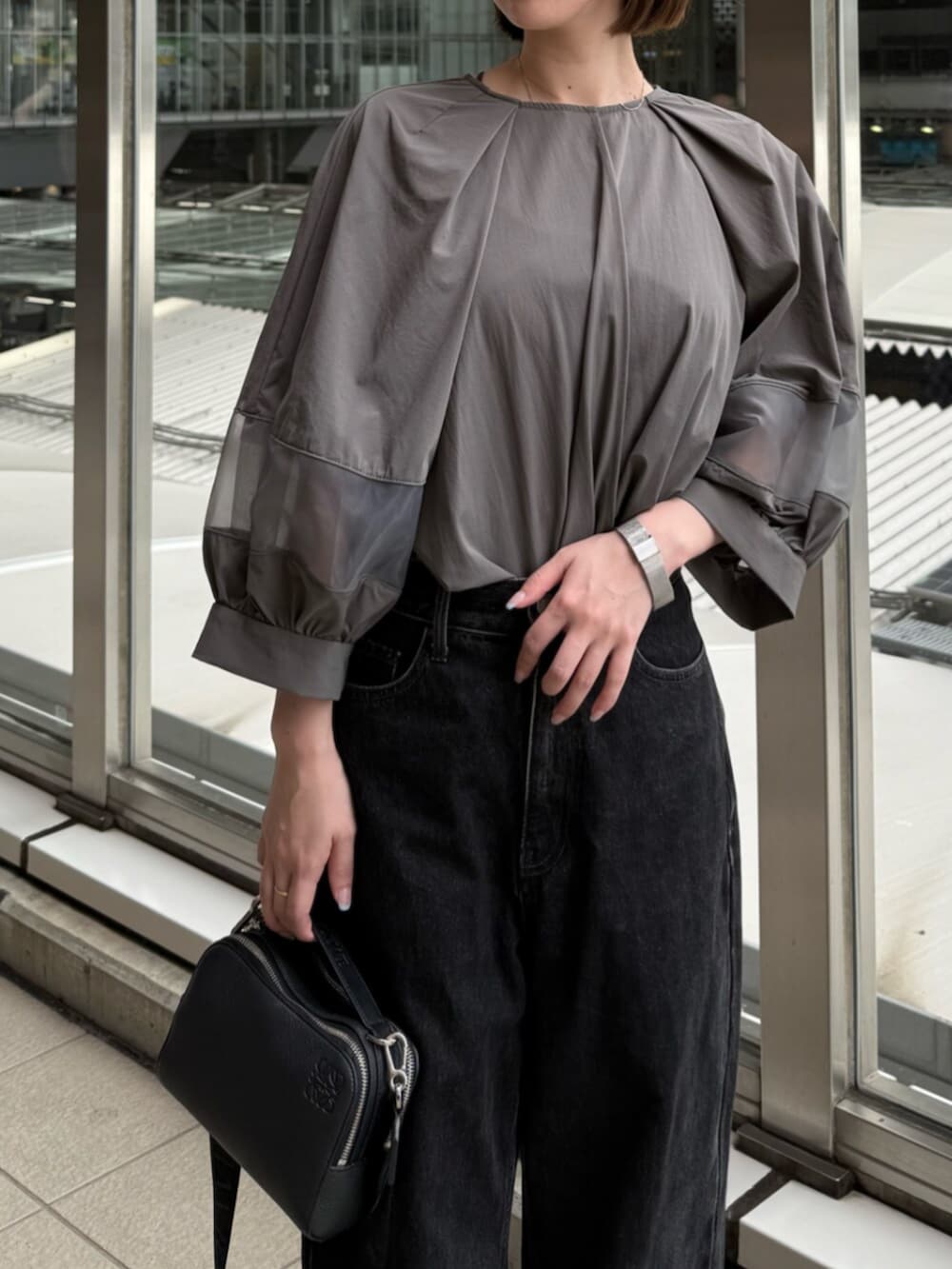 ブラック系のデニムパンツ、グレー系のシャツ/ブラウスを着用したレディースの夏コーディネートの4枚目の写真