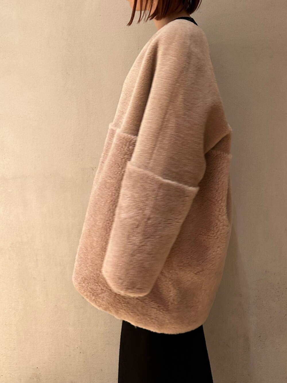 ブラック系のスカート、ブラック系のブーツ、ベージュ系のノーカラーコートを着用したレディースの夏コーディネートの8枚目の写真