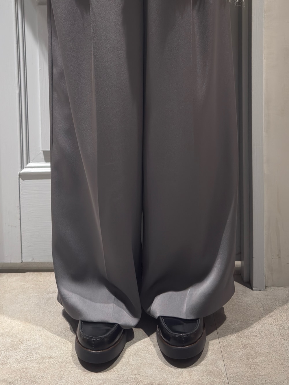 レッド系のカーディガン/ボレロ、グレー系のその他パンツ、ブラック系のローファーを着用したレディースの冬コーディネートの8枚目の写真