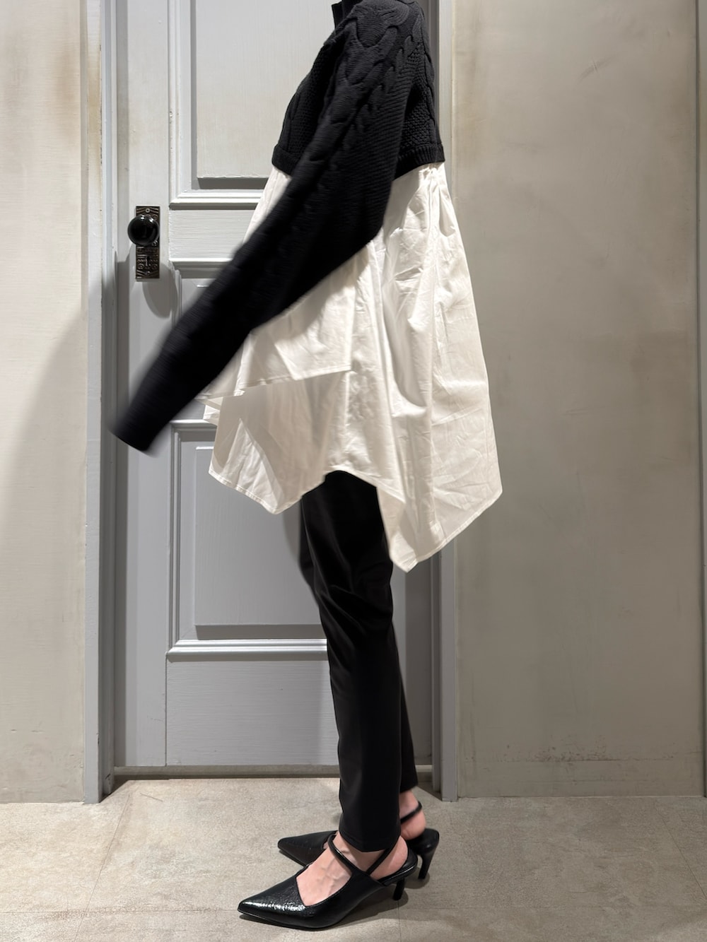 ブラック系のニット/セーター、ブラック系のその他パンツ、ブラック系のパンプスを着用したレディースの秋コーディネートの2枚目の写真