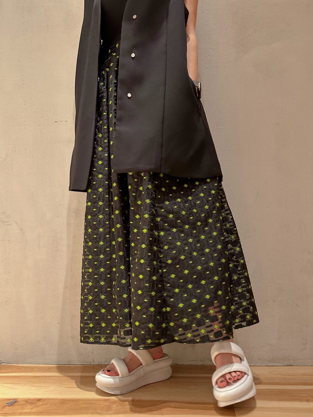 ブラック系のテーラードジャケット、その他のスカート、ホワイト系のサンダルを着用したレディースの冬コーディネートの6枚目の写真