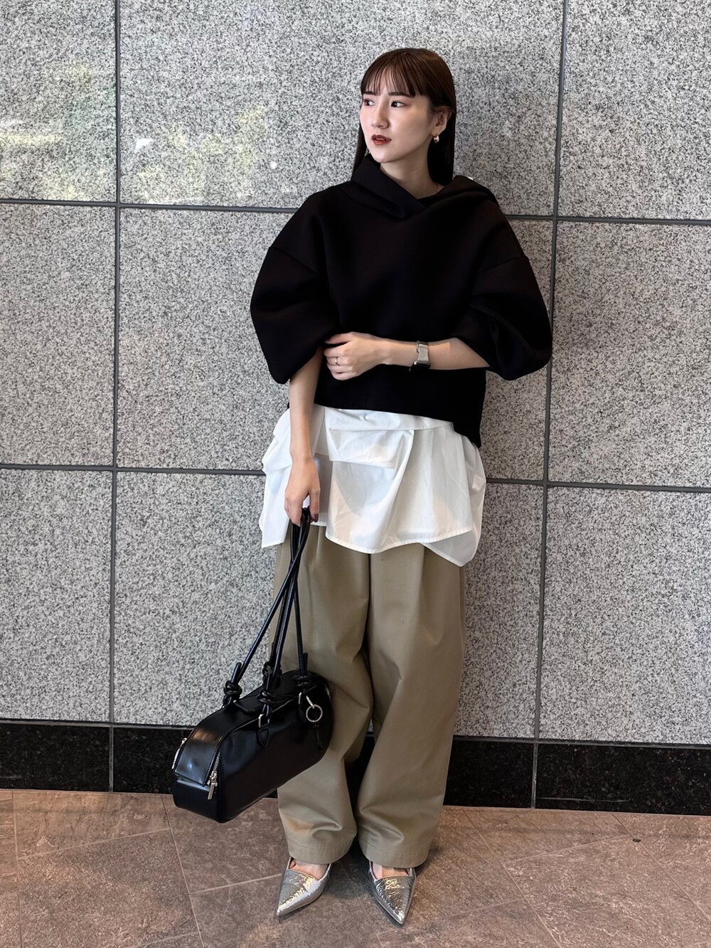 ベージュ系のその他パンツ、ブラック系のボストンバッグ、ブラック系のパーカーを着用したレディースの秋コーディネートの2枚目の写真