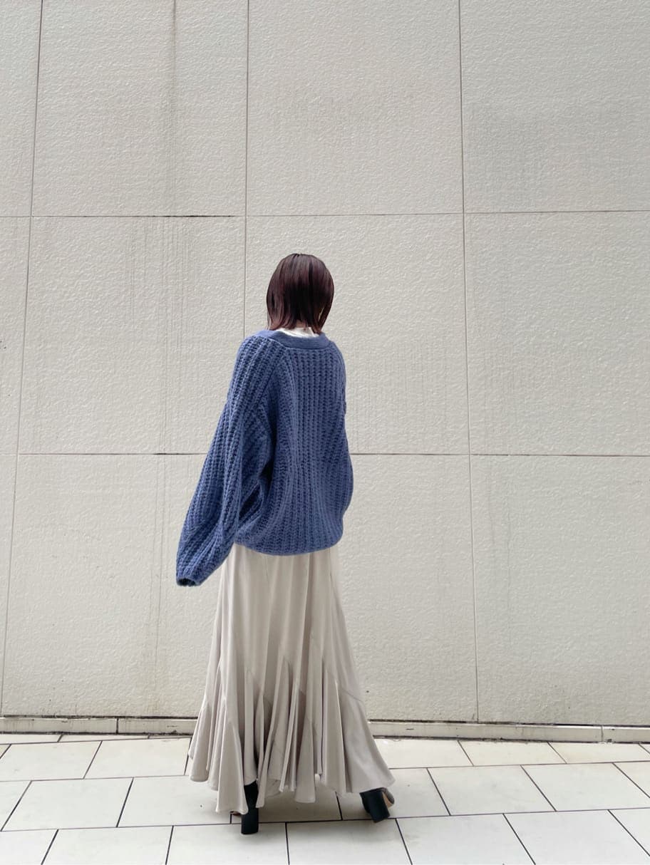 グレー系のニット/セーター、グレー系のスカート、ブラック系のその他シューズを着用したレディースの秋コーディネートの3枚目の写真