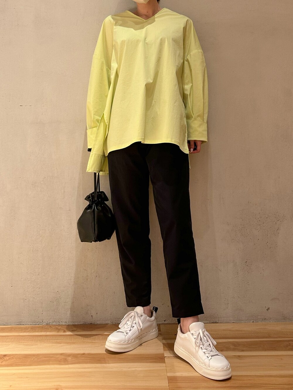 イエロー系のシャツ/ブラウス、ブルー系のその他パンツ、ホワイト系のスニーカーを着用したレディースの春コーディネートの3枚目の写真