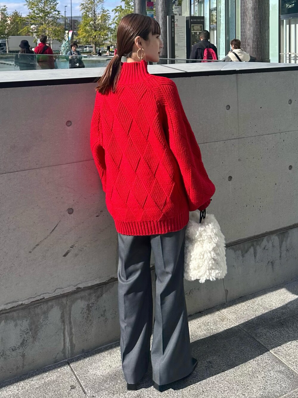 ブラック系のその他アウター、レッド系のニット/セーター、グレー系のその他パンツを着用したレディースの冬コーディネートの7枚目の写真