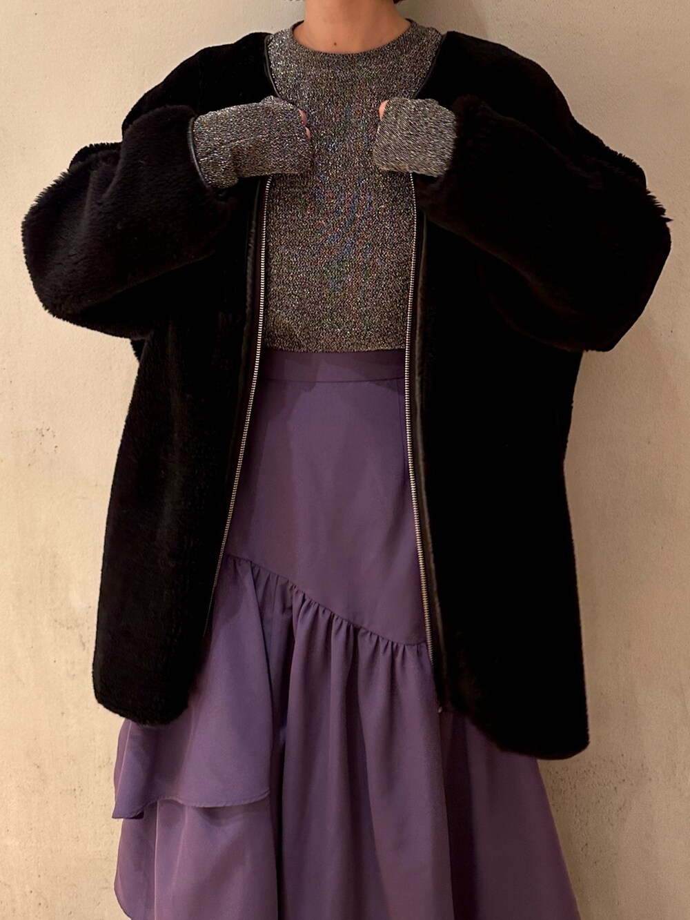 パープル系のスカート、ブラック系のノーカラーコート、シルバー系のTシャツ/カットソーを着用したレディースの秋コーディネートの8枚目の写真