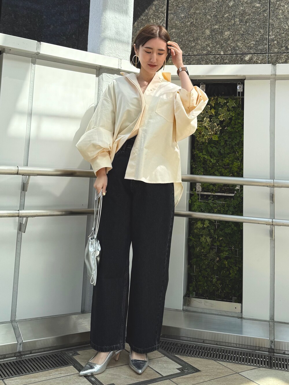 イエロー系のシャツ/ブラウス、シルバー系のショルダーバッグ、シルバー系のサンダルを着用したレディースの春コーディネートの2枚目の写真