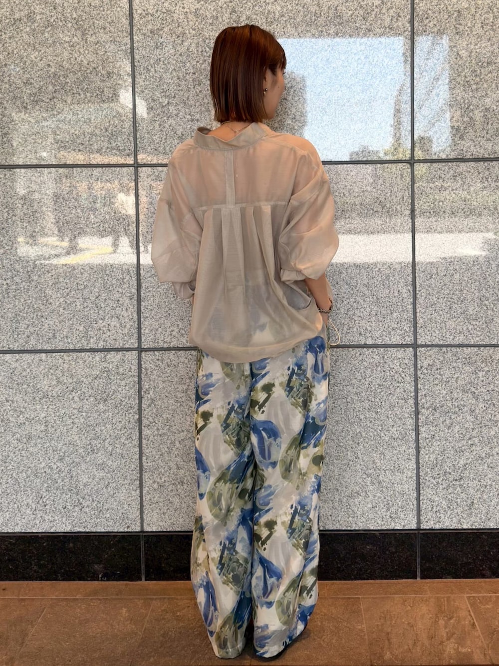 ベージュ系のブルゾン、ブルー系のその他パンツ、ブラウン系のサンダルを着用したレディースの春コーディネートの3枚目の写真