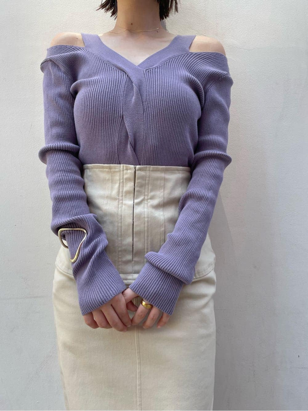 ブラウン系のパンプス、ベージュ系のスカート、パープル系のニット/セーターを着用したレディースの夏コーディネートの3枚目の写真