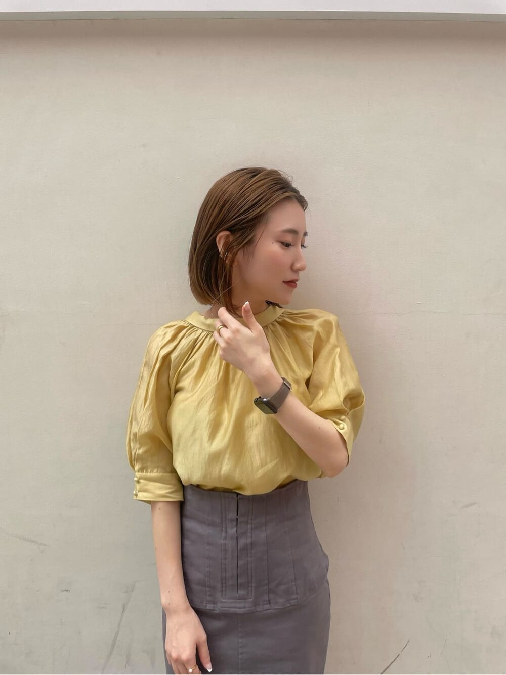 その他のパンプス、グレー系のスカート、イエロー系のシャツ/ブラウスを着用したレディースの夏コーディネートの4枚目の写真