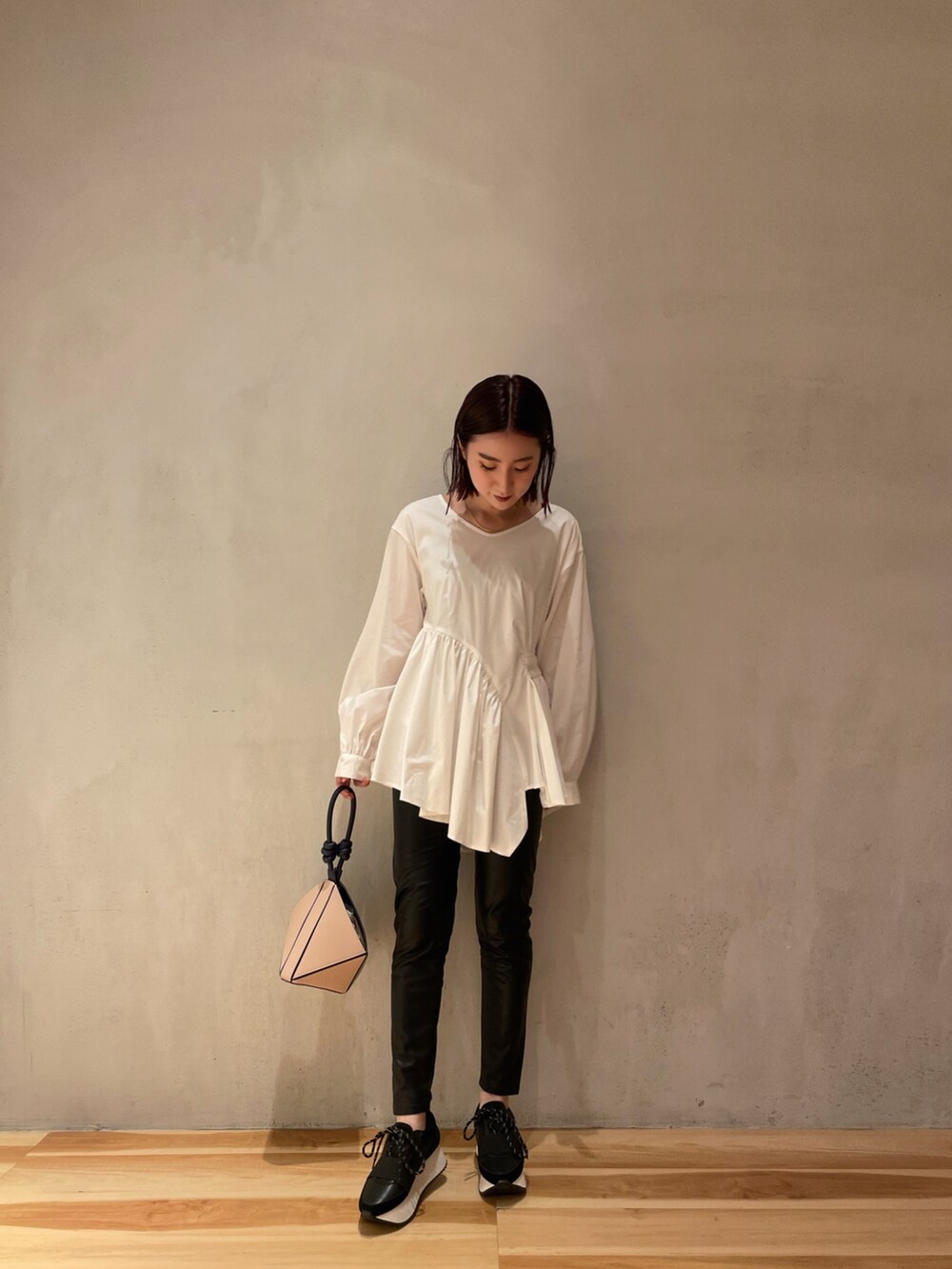 ホワイト系のシャツ/ブラウス、ブラック系のその他パンツ、ベージュ系のハンドバッグを着用したレディースの秋コーディネートの6枚目の写真