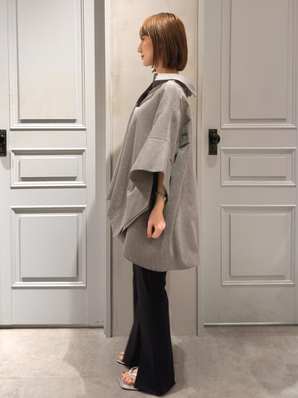 ブラック系のその他パンツ、グレー系のシャツ/ブラウスを着用したレディースの春コーディネートの3枚目の写真