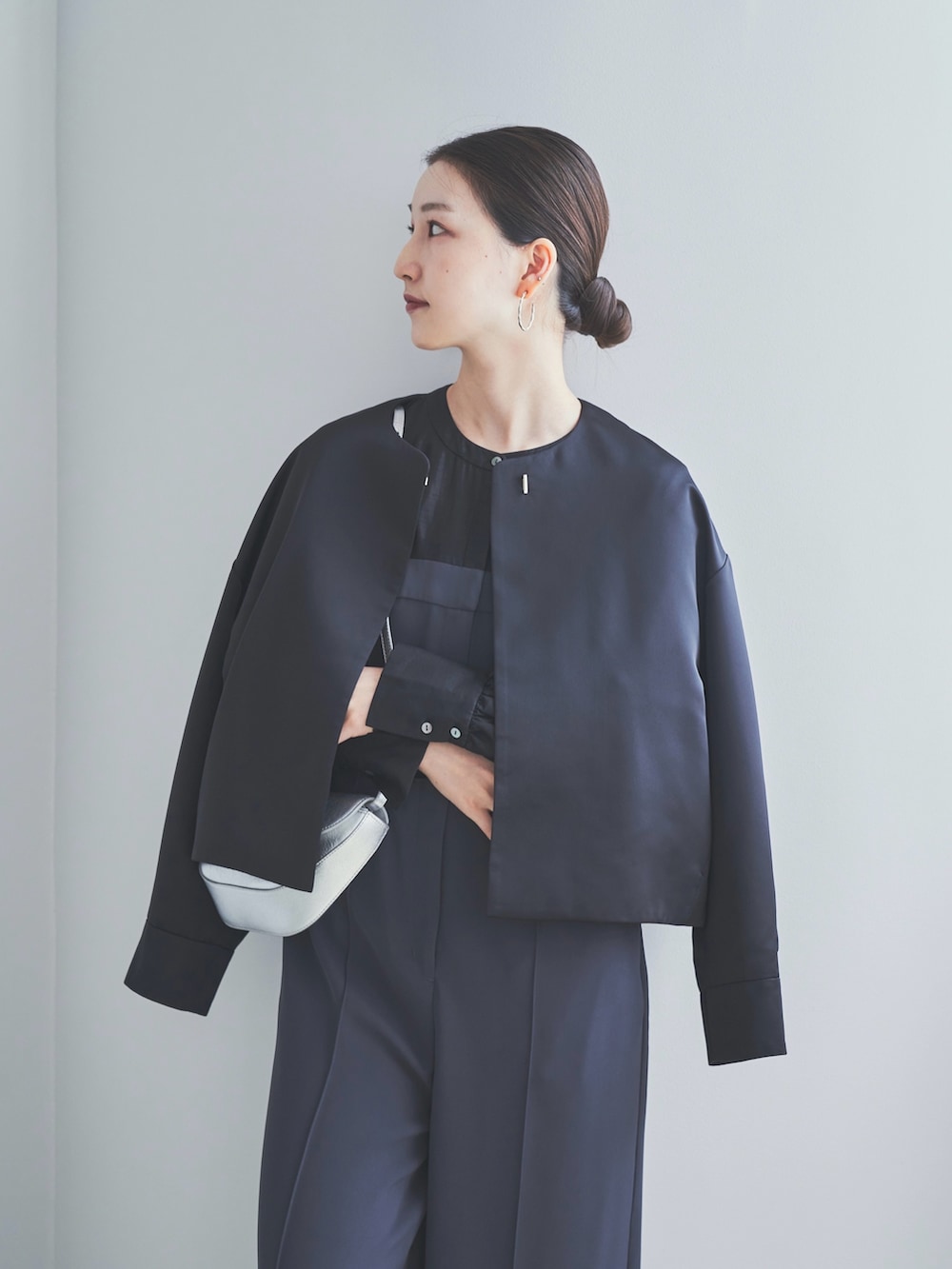 グレー系のその他パンツ、シルバー系のパンプス、シルバー系のショルダーバッグを着用したレディースの秋コーディネートの2枚目の写真