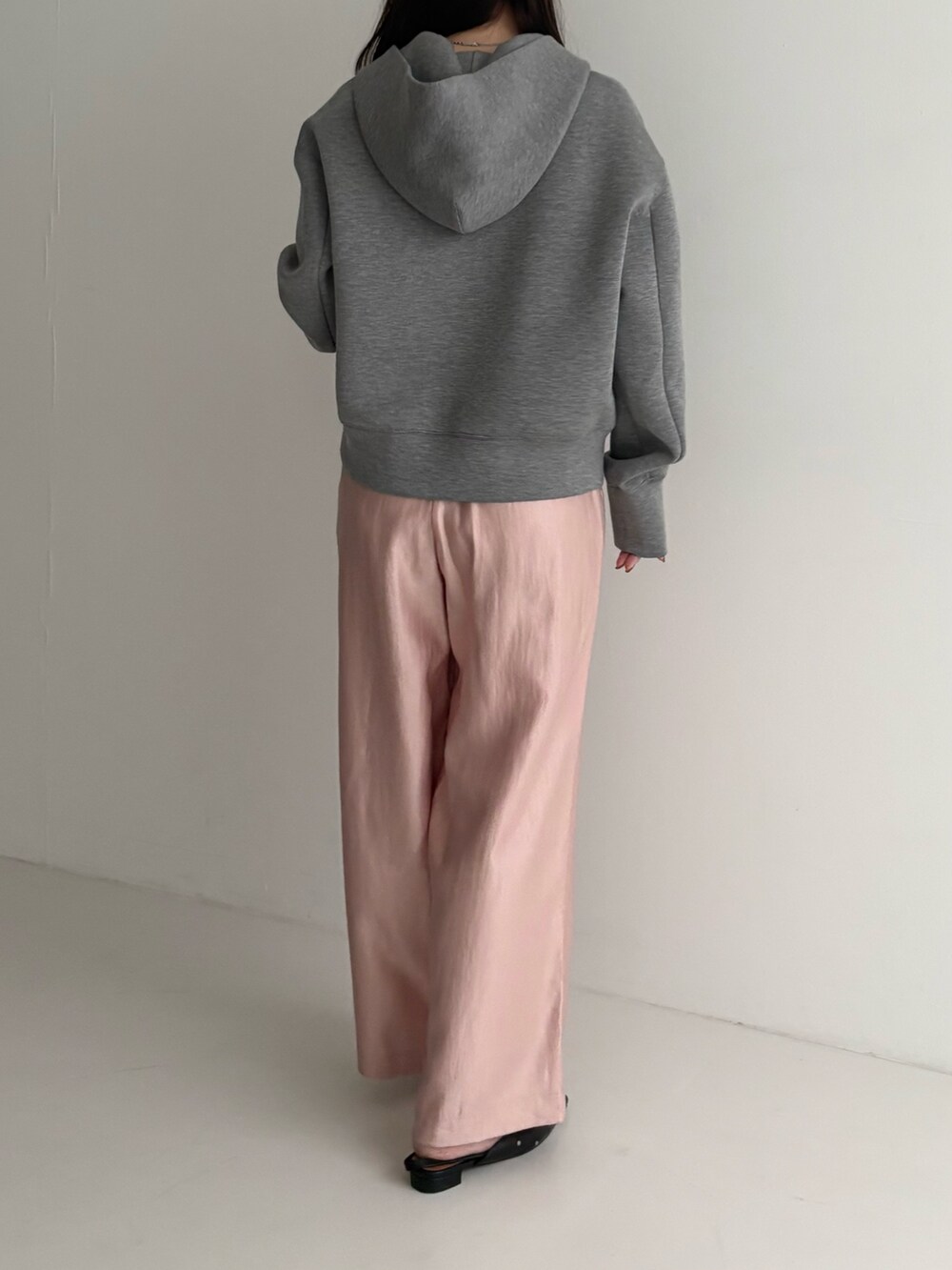 グレー系のパーカー、ピンク系のその他パンツを着用したレディースの秋コーディネートの3枚目の写真