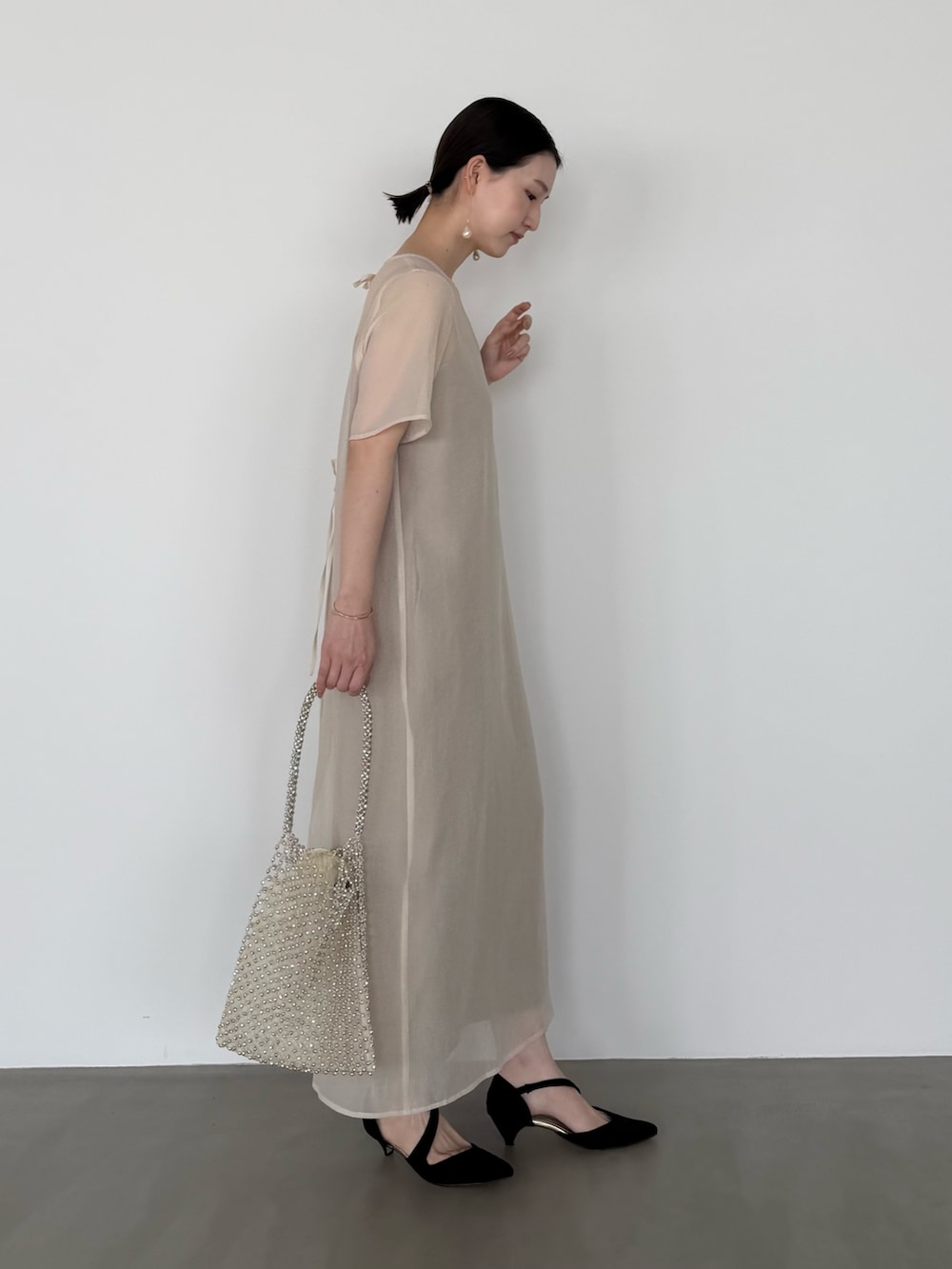 ホワイト系のワンピース、ブラック系のシューズ小物/雑貨を着用したレディースの春コーディネートの4枚目の写真