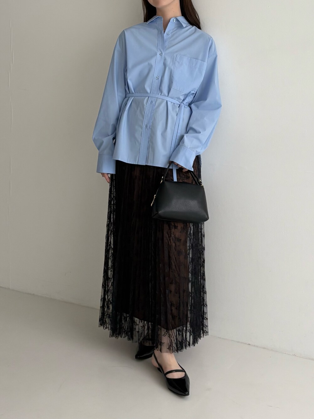 ブルー系のシャツ/ブラウス、ブラック系のスカートを着用したレディースの秋コーディネートの2枚目の写真