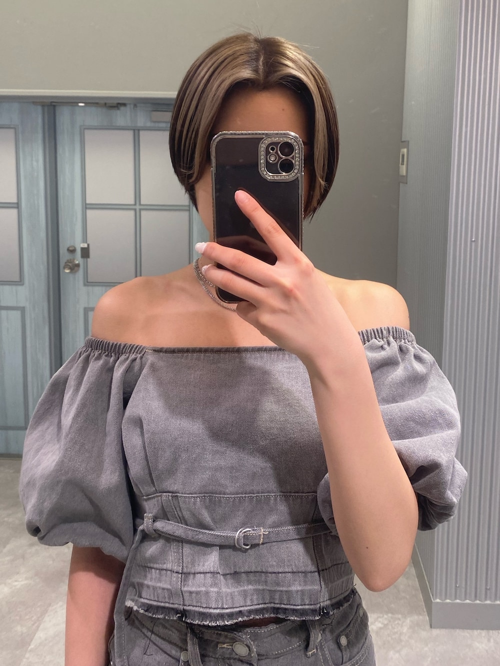 グレー系のシャツ/ブラウス、グレー系のスカート、ホワイト系のサンダルを着用したレディースの春コーディネートの4枚目の写真