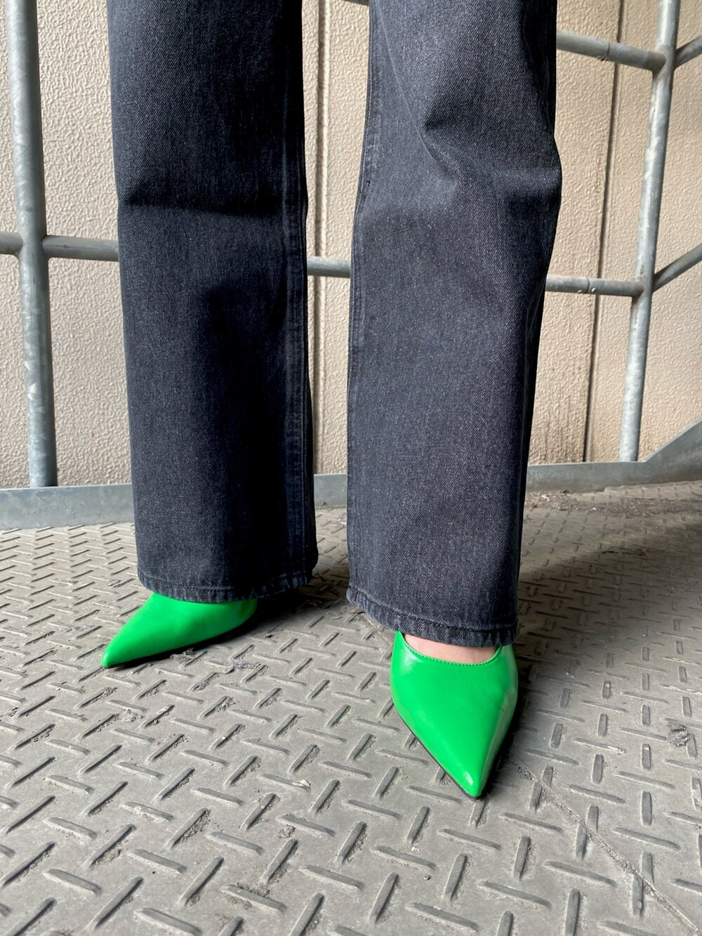 ブラック系のデニムパンツ、グリーン系のパンプス、ブラック系のその他トップスを着用したレディースの春コーディネートの5枚目の写真