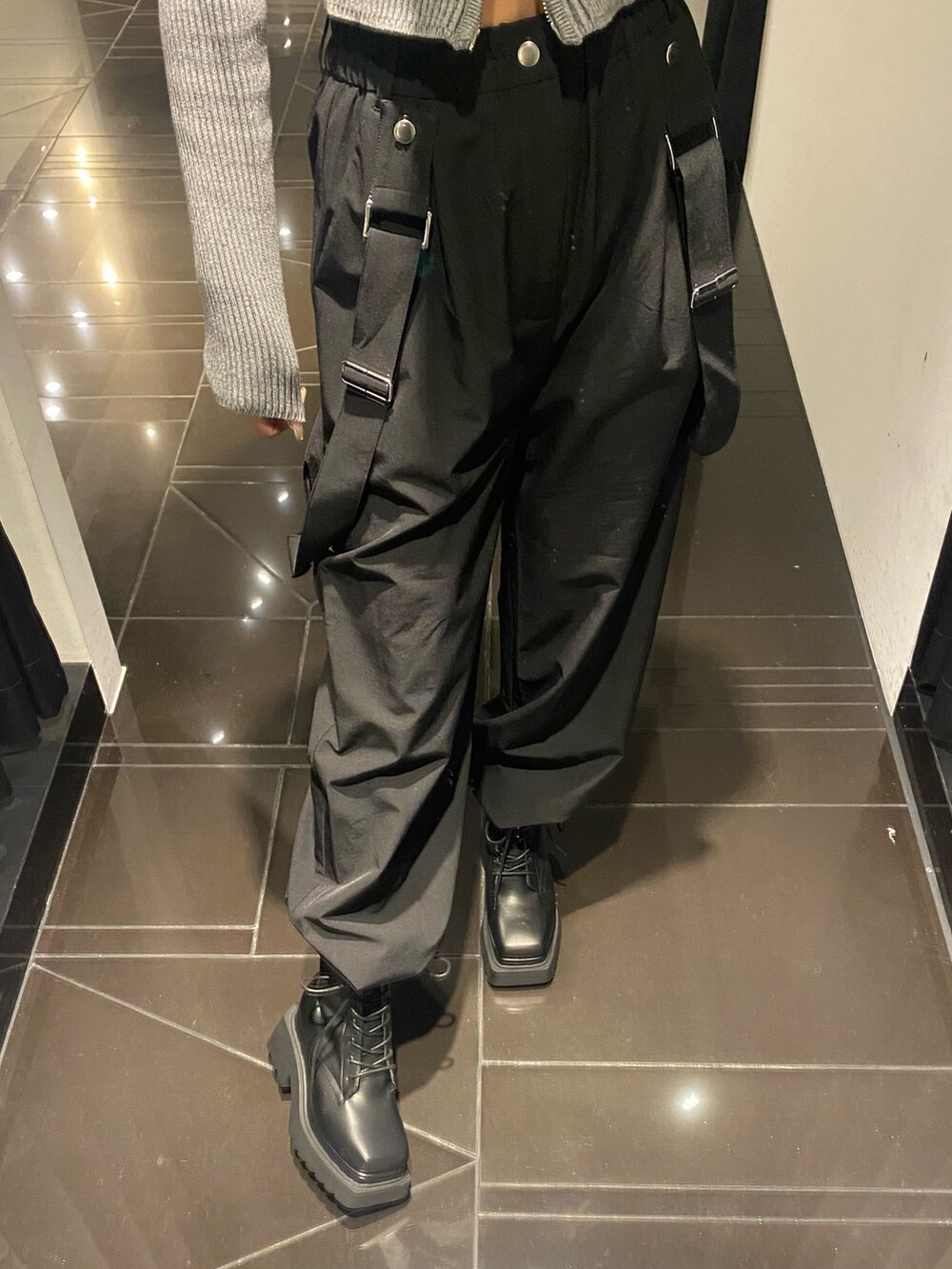 グレー系のニット/セーター、ブラック系のその他パンツ、ブラック系のブーツを着用したレディースの冬コーディネートの5枚目の写真