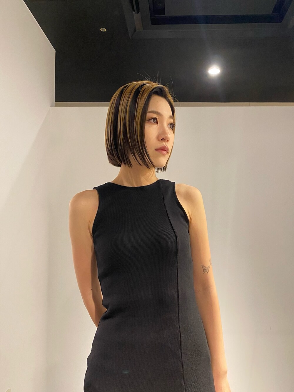 ホワイト系のブーツ、その他のハンドバッグ、ブラック系のワンピースを着用したレディースの春コーディネートの4枚目の写真