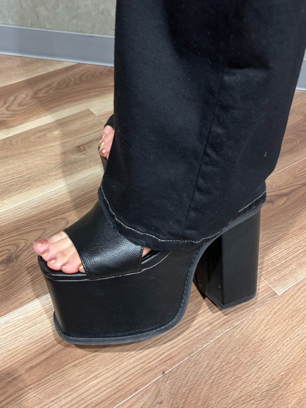 ブラック系のサンダル、ブラック系のデニムパンツ、ブラック系のTシャツ/カットソーを着用したレディースの春コーディネートの6枚目の写真