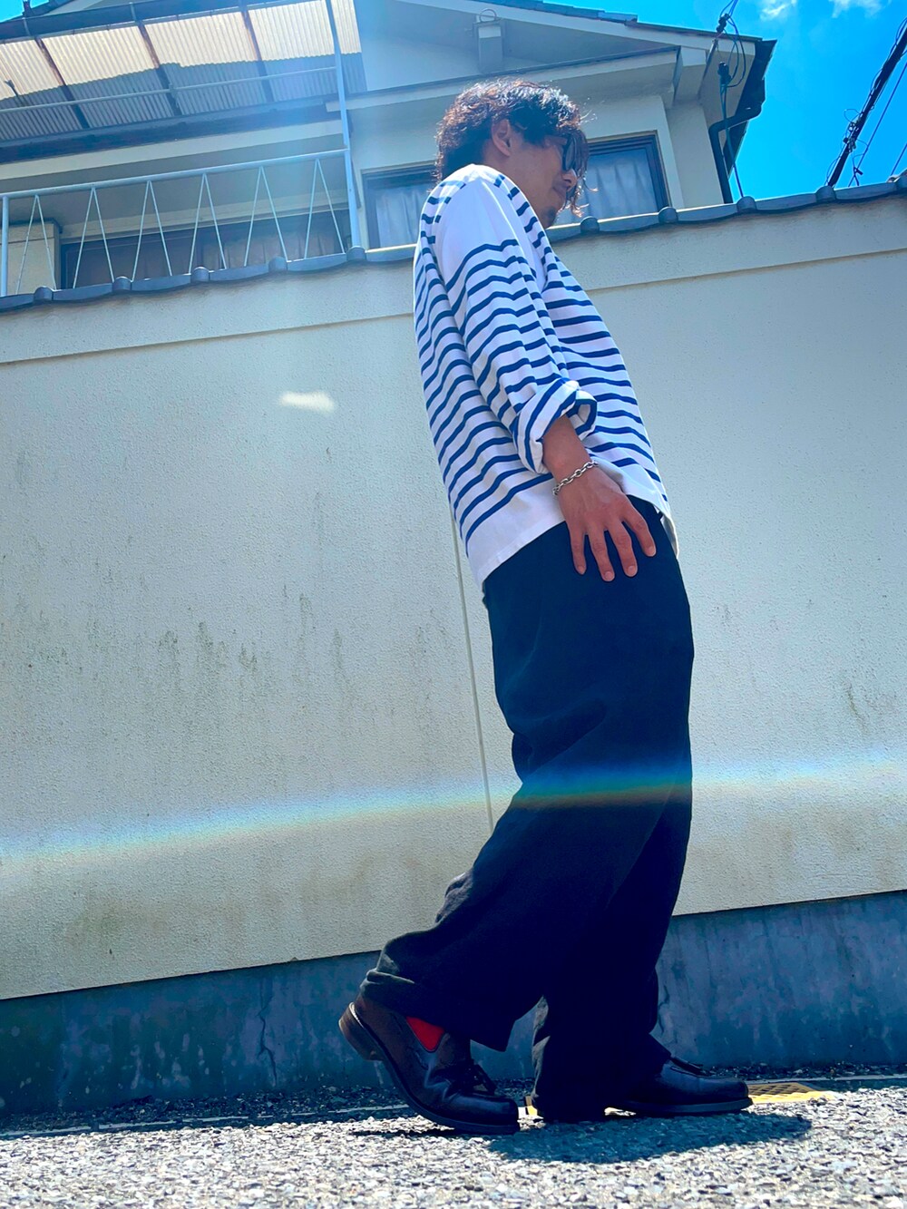 ホワイト系のTシャツ/カットソー、ブラウン系のローファー、ブラック系のパンツを着用したメンズの春コーディネートの2枚目の写真