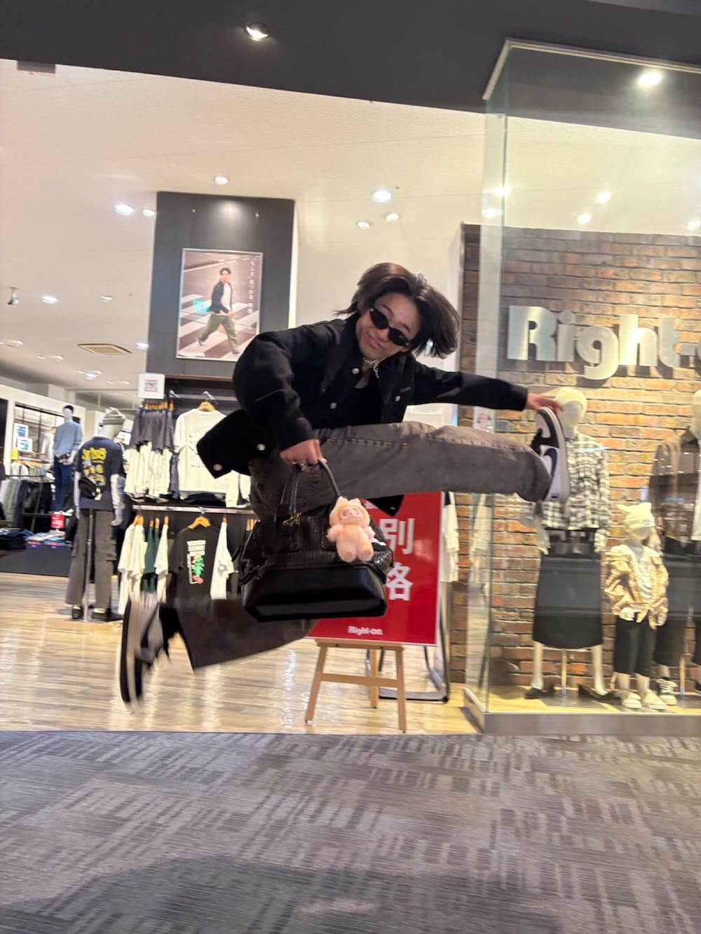 ブラック系のデニムジャケット、グレー系のデニムパンツ、ブラック系のスニーカーを着用したメンズの秋コーディネートの4枚目の写真