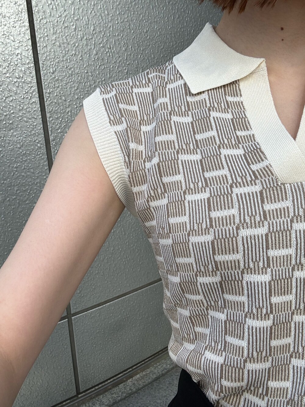 ブラック系のスカート、ブラック系のショルダーバッグ、ホワイト系のニット/セーターを着用したレディースの春コーディネートの7枚目の写真