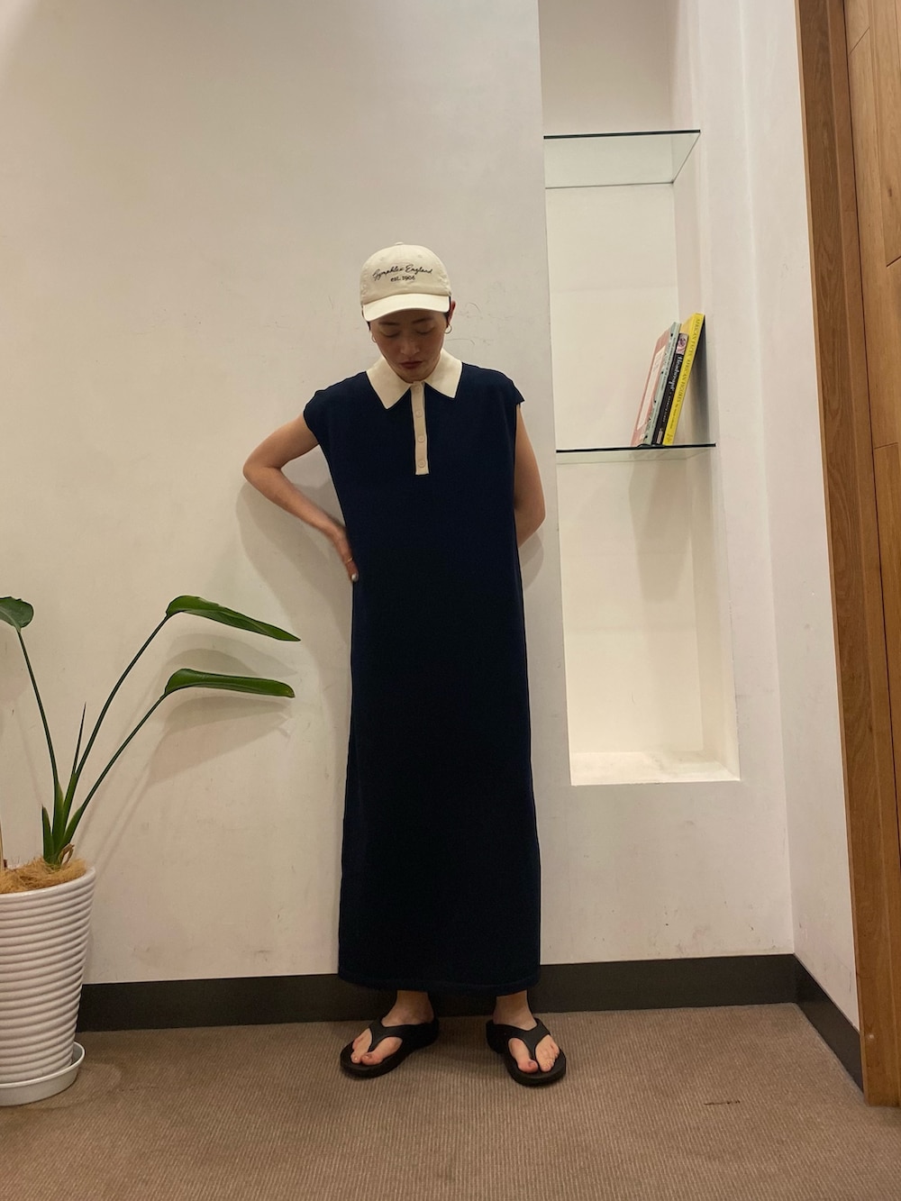 ブルー系のワンピース、ブラック系のサンダル、ホワイト系のキャップを着用したレディースの夏コーディネートの4枚目の写真