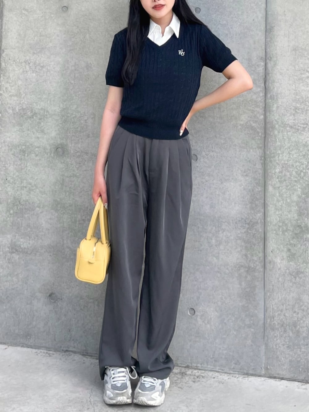 ブルー系のニット/セーター、ホワイト系のシャツ/ブラウス、グレー系のスラックスを着用したレディースの夏コーディネートの3枚目の写真