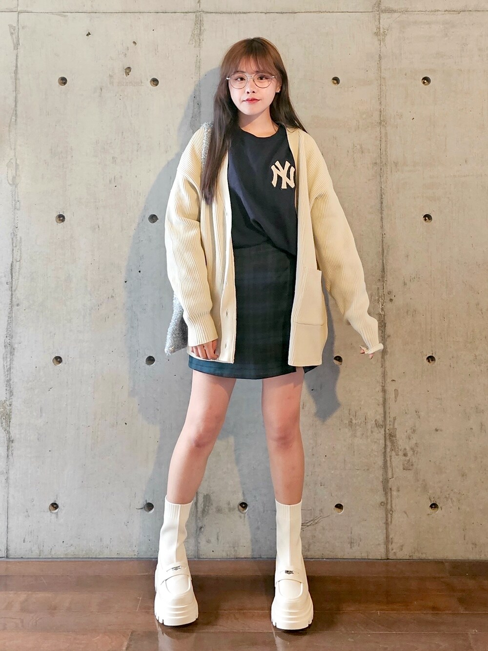 ホワイト系のカーディガン/ボレロ、グリーン系のスカート、シルバー系のショルダーバッグを着用したレディースの秋コーディネートの4枚目の写真