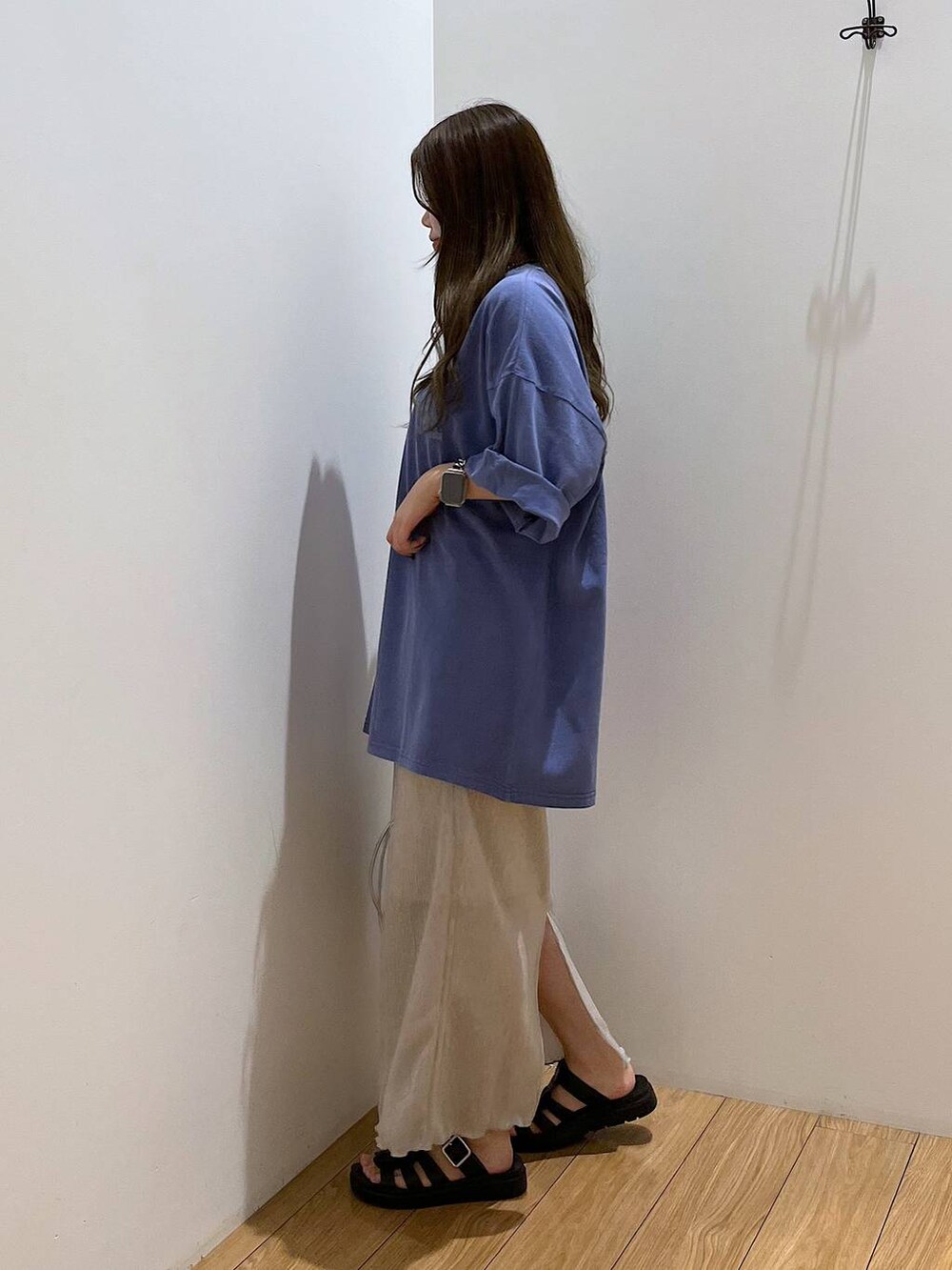 ホワイト系のスカート、ブルー系のTシャツ/カットソー、ブラック系のスニーカーを着用したレディースの夏コーディネートの3枚目の写真