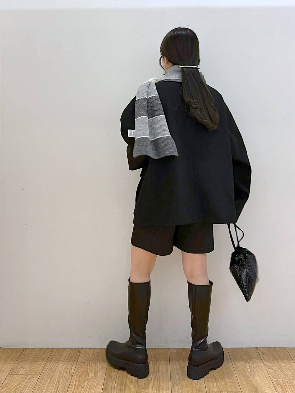 ブラック系のブルゾン、ブラック系のその他パンツ、ブラック系のブーツを着用したレディースの冬コーディネートの5枚目の写真