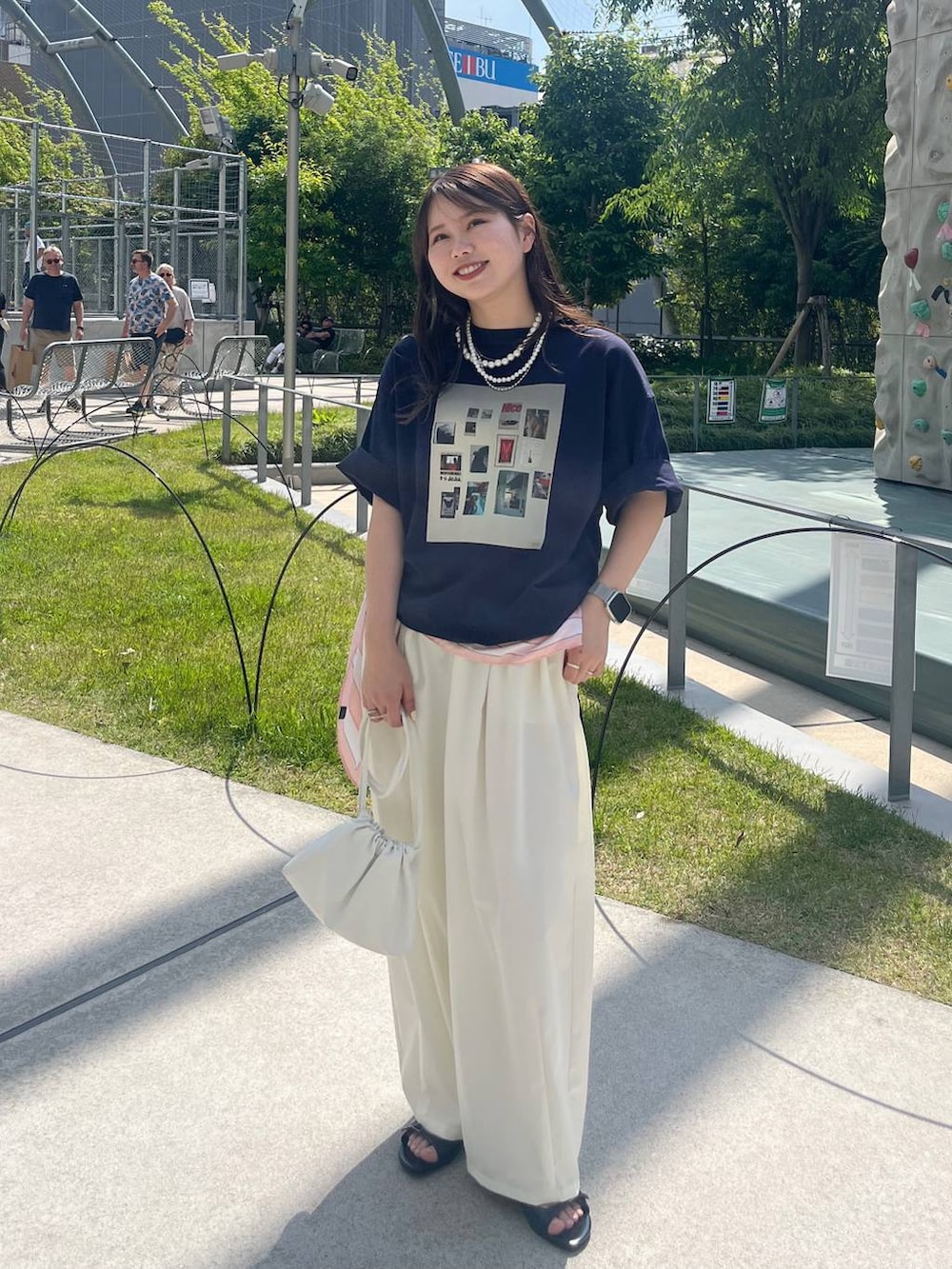 ホワイト系のその他パンツ、ホワイト系のショルダーバッグ、ベージュ系のネックレスを着用したレディースの春コーディネートの6枚目の写真