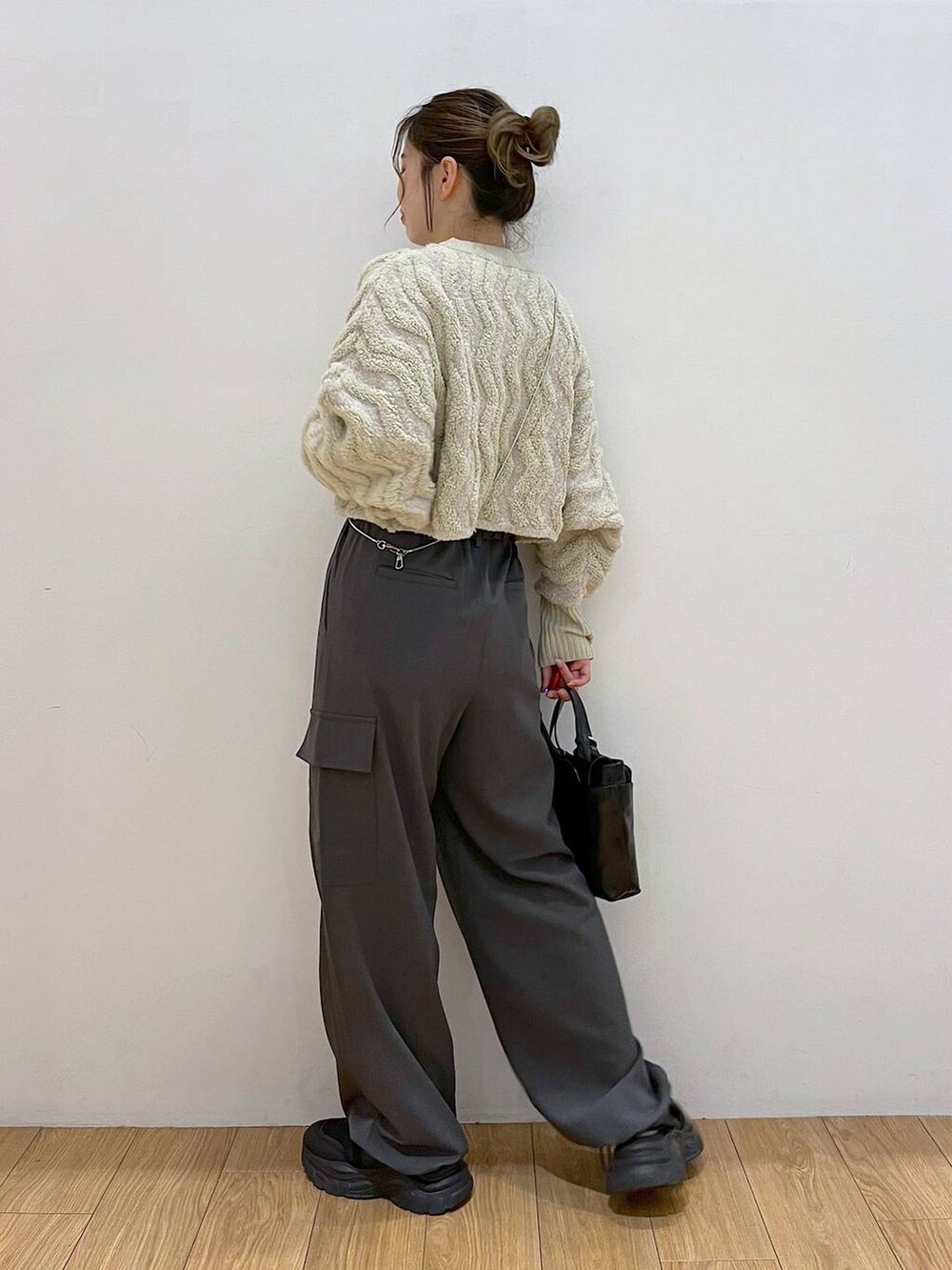 ブラック系のショルダーバッグ、グレー系のその他パンツ、ホワイト系のニット/セーターを着用したレディースの秋コーディネートの6枚目の写真